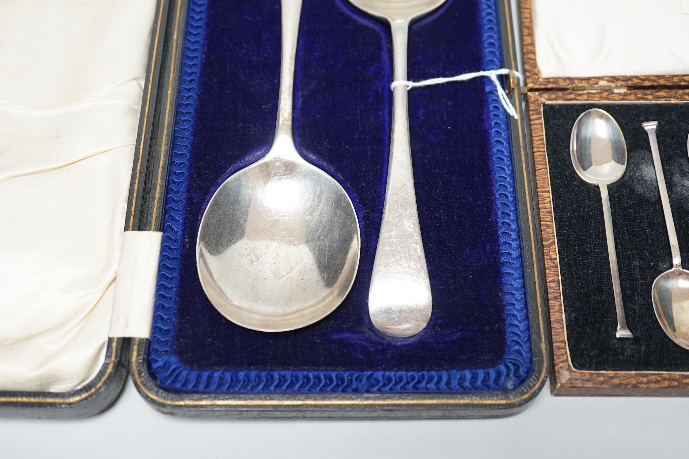 A set of six George V silver seal top coffee spoon, cased, and a pair of George V silver old English pattern fruit spoons, Sheffield, 1916, cased.